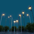 Municipal Road With Illuminated Street Lamps Under Night Sky And Trees