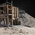 Rugged Landscape Featuring Old Wooden Shed Sand Pile On Barren Ground Under Dark Sky