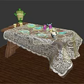 Wooden Coffee Table With White Lace Tablecloth And Gold Teapot Blue Teacups Plates