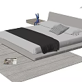Double Bed with Gray Headboard White Pillows Black Blanket on Gray Rug and Nightstand Plant