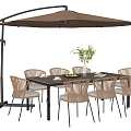 Outdoor Dining Table and Woven Rattan Chairs Set with Patio Umbrella and Potted Plant