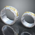 Two Silver Gold Decorative Rings With Textured Surface And Intricate Designs