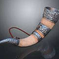 Handcrafted Musical Instrument Horn With Silver Carved Patterns Light Colored Body And Red String