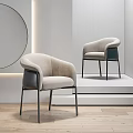 Modern Beige Accent Chairs With Curved Design And Black Metal Legs In Minimalist Showcase