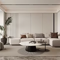 Modern Living Room Featuring Light Sofa Colored Cushions Round Coffee Table And Large Green Plant