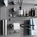 Sleek Modern Bathroom Accessories With Towel Bars Towels Aromatherapy Sticks And Toiletries On Gray Wall
