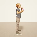 Young Man In Gray Tshirt And Khaki Pants Holding Purple Item