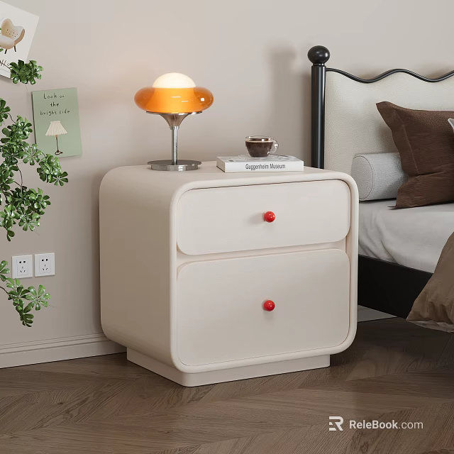 Cream Two Drawer Bedside Table With Red Knobs Orange Lamp Book And Green Plant 3d model