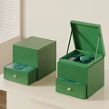 Two Open Green Boxes With Tea Inside Placed On White Table 3d model