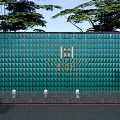 Green Diamond Pattern Feature Wall With Golden Logo Trees Background And Bottom Lights 3d model