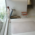 Minimalist Living Room with Large Glass Windows Trees Outside Natural Light Tan Sofa Treadmill and Staircase
