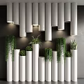 Bonsai Potted Plants in White Cylindrical Containers on Dark Wall with Hanging Greenery and Lighting