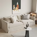 Beige Two Seater Sofa with Throw Pillows Round Coffee Table and Abstract Wall Art
