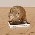 Chanel The Vocabulary of Style Book With Golden Decorative Sculpture On Wooden Floor