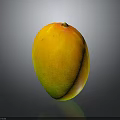 Fresh Ripe Mango Fruit With Vibrant Yellow And Green Skin On Dark Background