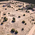 Desert Garden Landscape With Scattered Trees Winding Paths And Traditional Buildings