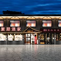 Warm Traditional Chinese Restaurant Interior With Food Display Shelves Beverage Coolers And Wooden Decor