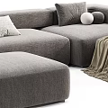 Modern Sectional Sofa Set With Grey White Upholstery Pillows Blankets And Ottoman