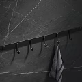 Black Bathroom Cabinet Rack with Multiple Hooks Hanging Gray Towel on Dark Marble Wall