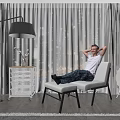 Modern Leisure Area Featuring Relaxing Man Comfortable Chair Floor Lamp Side Table And Large Window