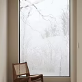 Leisure Chair With Wooden Frame Woven Seat By Frosted Glass Window Showing Winter Snow Branches