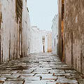 Ancient Stone Paved Alley With Weathered Walls On Both Sides Creating Rustic And Serene Atmosphere