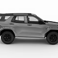Gray Off Road SUV With Large Tires Roof Rack And Rugged Front Design