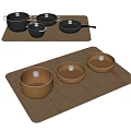 Black and Brown Cookware Set on Wooden Trays with Pots Pans and Lids