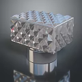 Woman Adorning Transparent Geometric Cube With Polished Metal Base