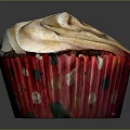 Delicious Fluffy Cupcake With Swirled Frosting And Red Polka Dot Wrapper