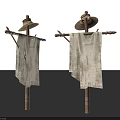 Two Scarecrows With Straw Hats And Worn Cloth On Wooden Poles