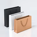 Three Colored Paper Shopping Bags with Handles in Black White and Brown