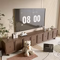 Brown TV Cabinet In Living Room With TV Teddy Bear Books Decorations Plant And Rug
