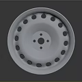 Silver Tire's Wheel Rim Featuring Multiple Circular Holes And Reflective Finish On Dark Background