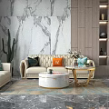 Round Marble Top Coffee Table With Gold Base Flower Vase And Plant On Patterned Rug