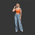 Blonde Woman In Orange Crop Top And Blue Wide Leg Jeans Standing Against Gray Background