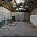 Abandoned Industrial Space Interior With High Ceiling Exposed Brick Walls And Concrete Floor