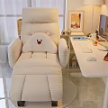 Beige Recliner Chair with Plush Bear Cushion in Cozy Home Office Space Beside White Desk
