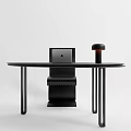Modern Minimalist Black Oval Desk With Laptop And Lamp Beside Stylish Wavy Chair