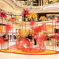Vibrant Mall Photo Spot With Colorful Art Installation And Palm Like Structures