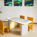 Modern Dining Table Set with Yellow Chairs Marble Tabletop Wall Art and Potted Plant