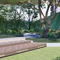Residential Landscape With Lush Trees Greenery Wooden Deck Lawn And Flower Beds