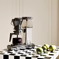 Stylish Modern Kitchen Coffee Maker Appliance On Counter With Fresh Limes