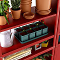 Red Storage Shelves And Cabinets With Potted Plants Terracotta Pots Wooden Crates And Books
