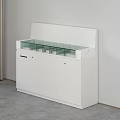 Modern White Reception Desk With Glass Countertop And Cabinet Storage In Minimalist Office Design