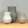 White Gray Beige Swirled Texture Vases With Small Feet On Wooden Tabletop