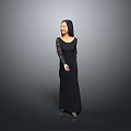 Elegant Woman In Black Long Dress With Lace Sleeves Standing Against Gray Background