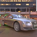 Silver Audi Car Parked In Urban City Street With Night Lights