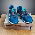 Blue Running Shoes With Multi Colored Laces And Supportive Sole On Brand Box