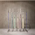 Modern Transparent Acrylic Clothing Rack with Various Colored Dresses Hanging in Minimalist Indoor Setting